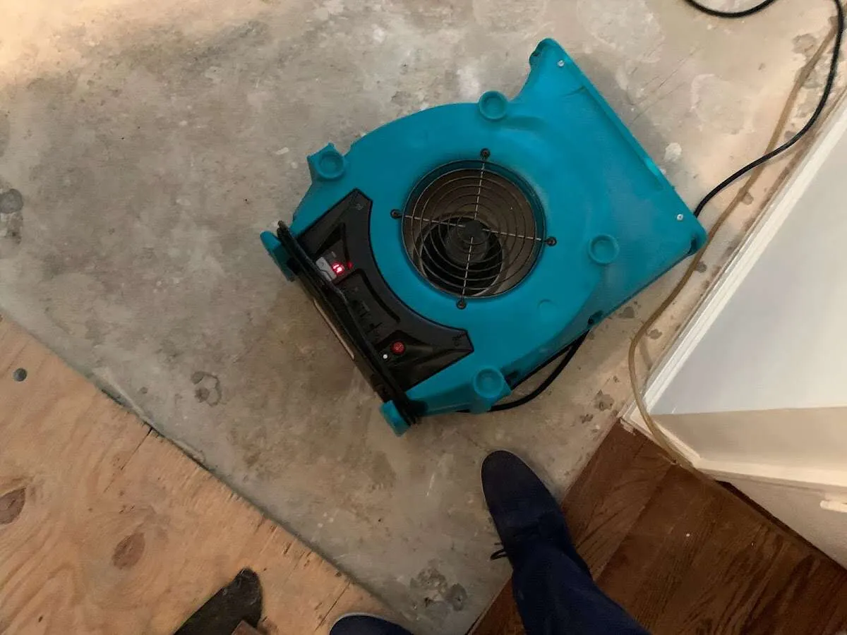 Air mover drying subfloor during Commercial Water Damage Restoration in Muskogee